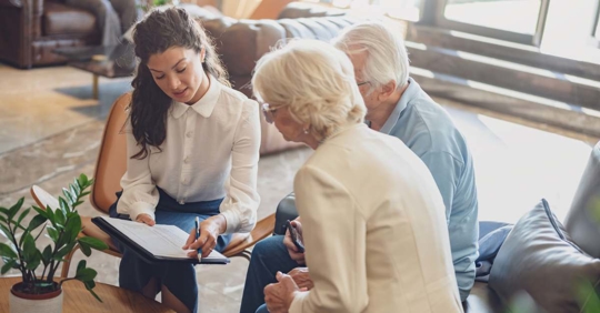 Law firm staff talking to senior couple