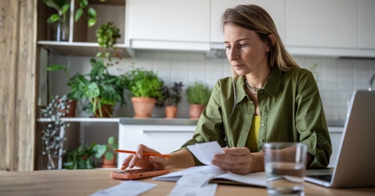 Focused woman calculating expenses