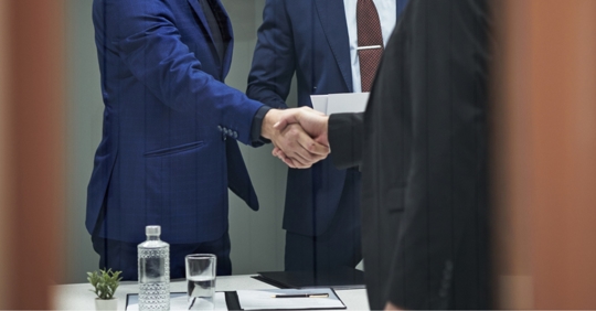 Handshake between an adult man and his chosen successor trustee or POA agent