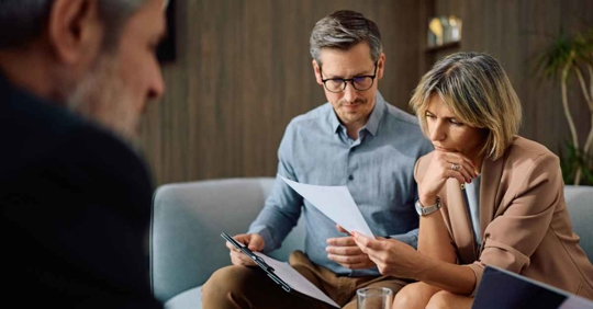 Mid adult woman and her husband going through their financial reports