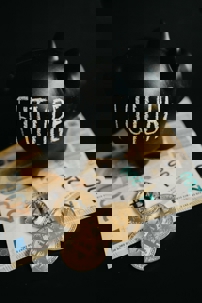 Black piggy bank labeled “FUTURE” placed on euro banknotes with several bitcoin coins in front, symbolizing savings and investment.